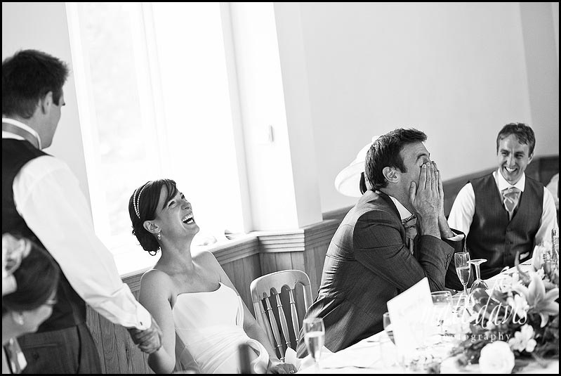 Laughing bride during wedding speeches at Delbury Hall 