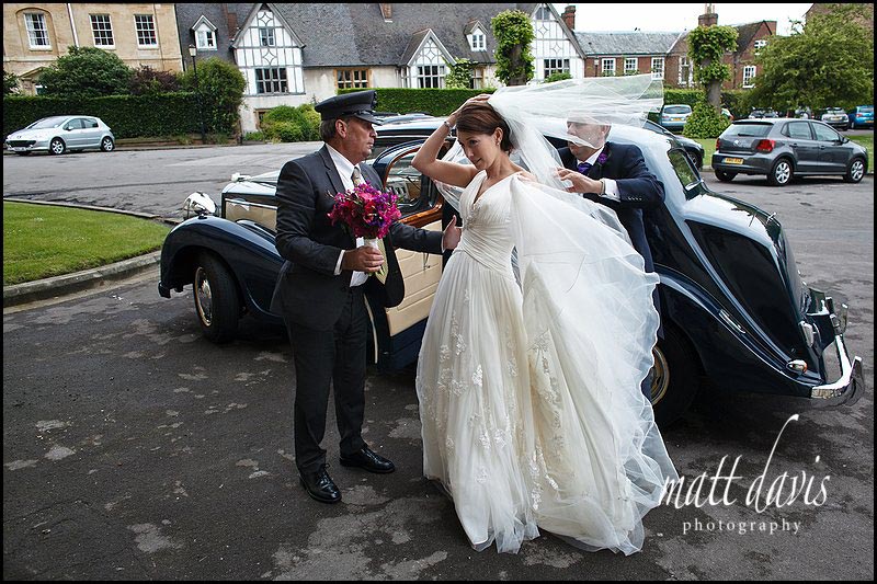 bride and vintage wedding car at Gloucester Cathedral