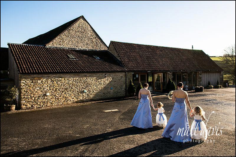 Winter weddings at Kingscote Barn showing bridesmaids in warm sun