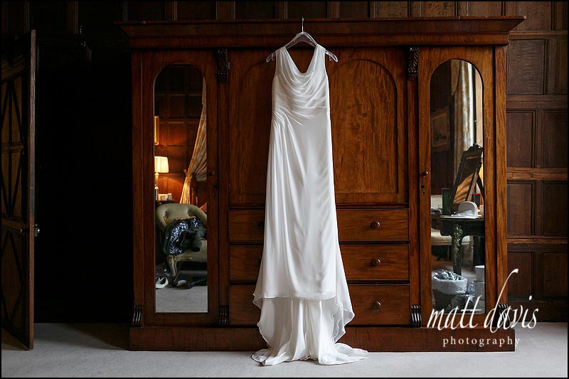 Wedding dress hung on wardrobe in bridal suite at Elmore Court